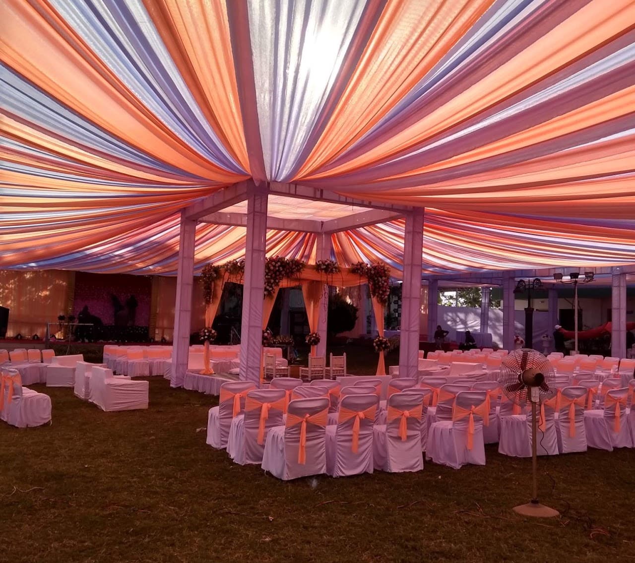 Outdoor wedding mandap under a radiating fabric canopy