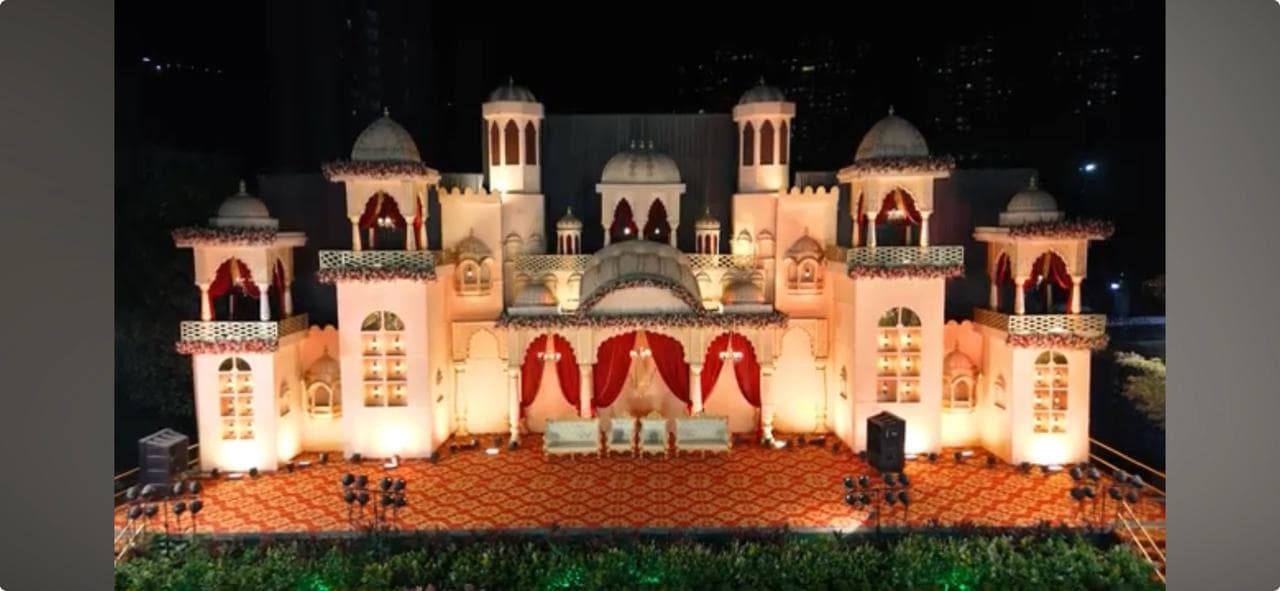Palace-style wedding stage glowing under evening lights